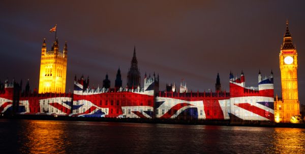 Union Jack flag projected onto the side of the houses of parliament