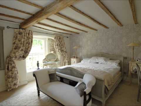 Bedroom with exposed wooden beams across the ceiling