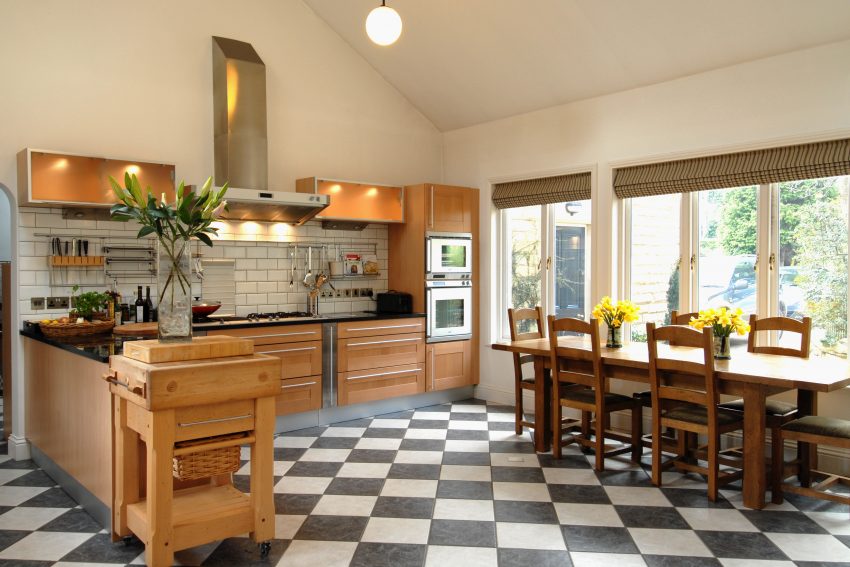 Kitchen interior with double height ceiling and dining table