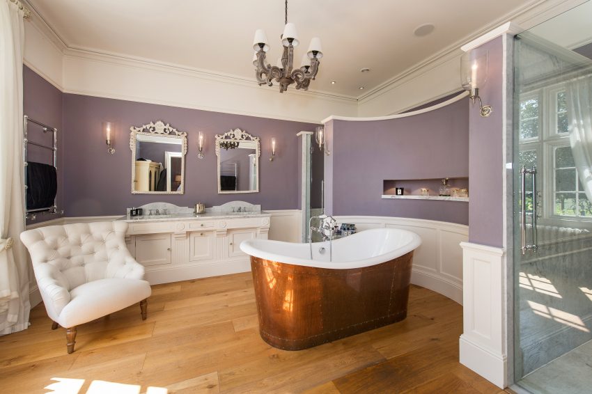 Large bathroom with roll top bath and showers