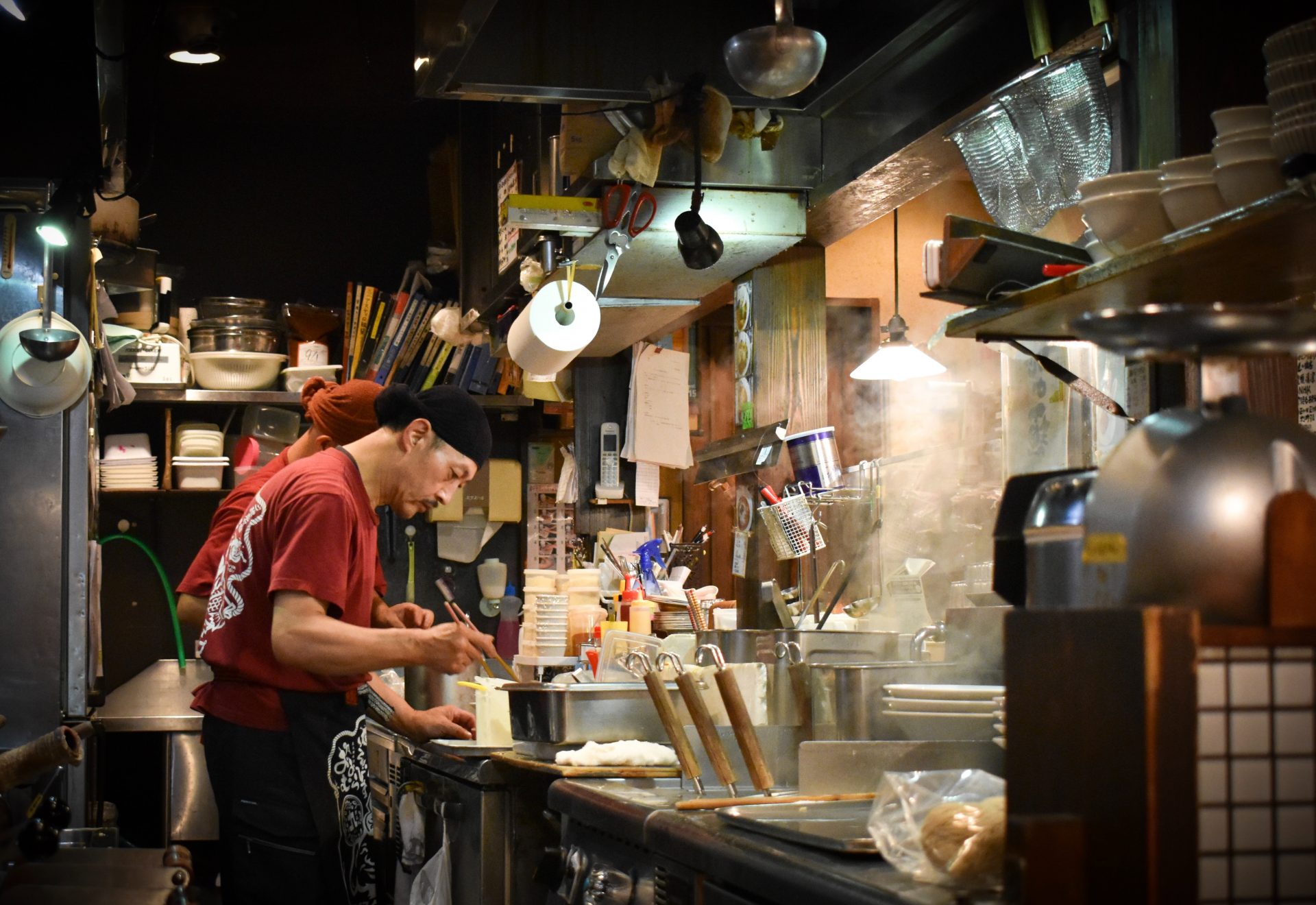 Chinese restaurant chefs cooking in a commercial kitchen