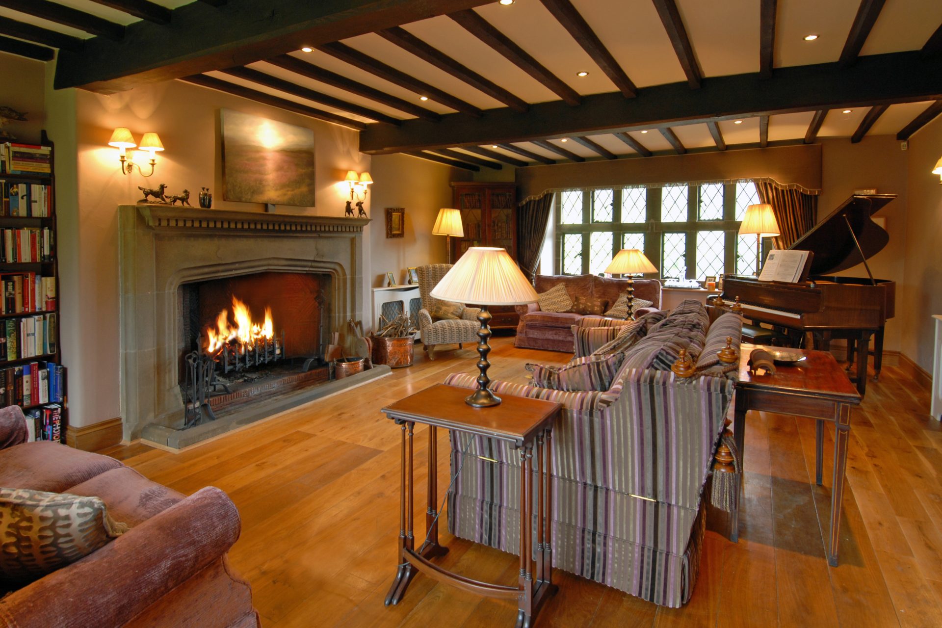 Luxurious family seating area with fireplace and piano