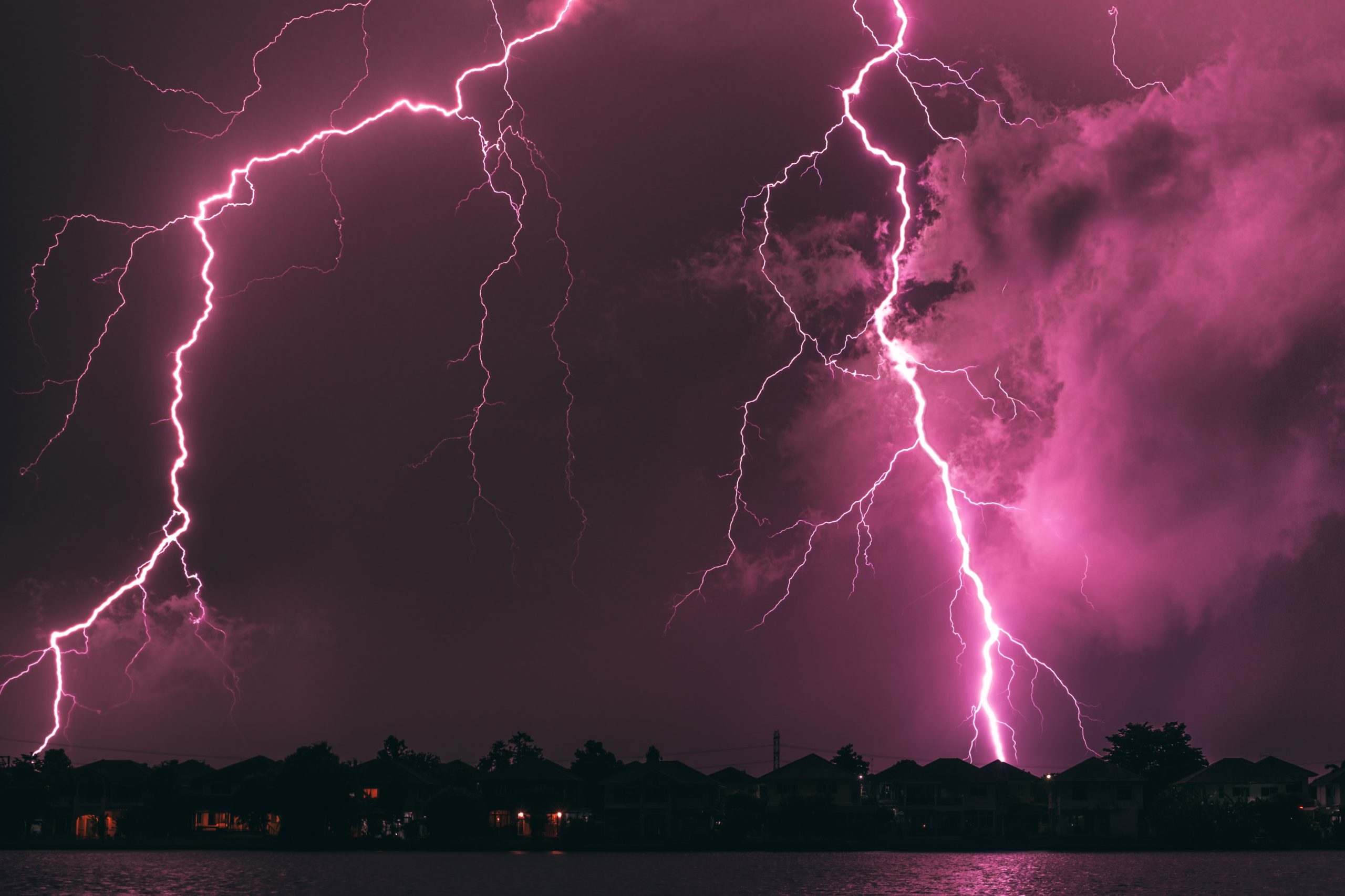 Lightening striking at night over a residential neighbourhood