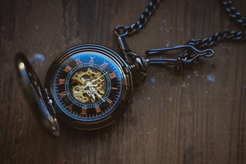 Vintage pocket watch on a wooden surface